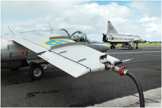Saab Sk60 SE-DXG being refuelled prior to an air-to-air photoshoot with the Viggen visible in the background