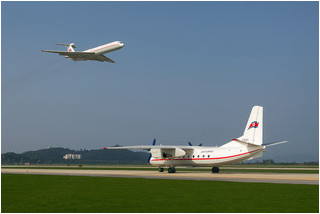 Air Koryo Antonov An-24 P-537 taxys for its display while Il-62 P-885 flies overhead