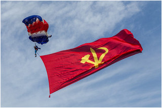 Pyongyang Air Club parachutist with the Korean Workers Party flag